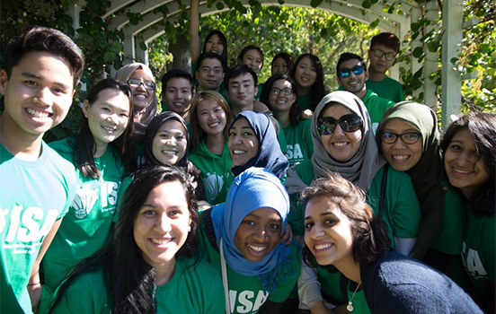 A multicultural mix of MSU students smiles at the camera